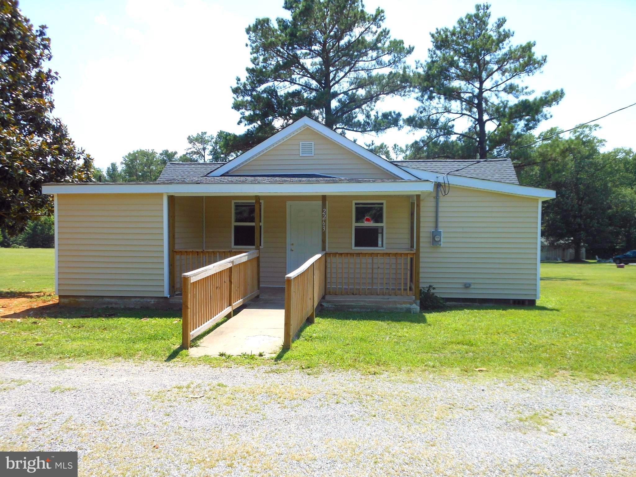 2263 Pomona Road Colonial Beach, VA 22443 - Photo 2 of 28 a front view of house with yard and trees in the background