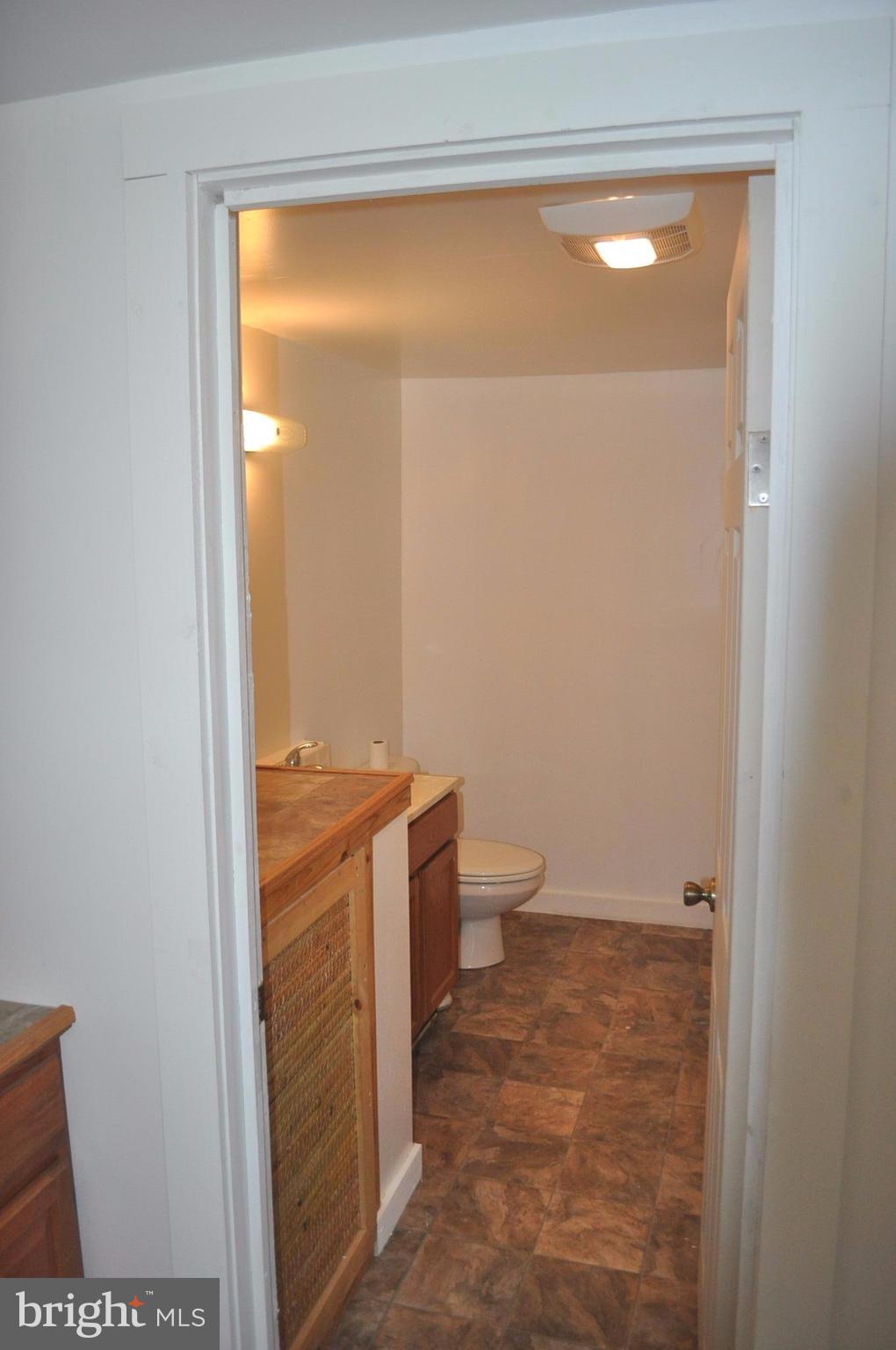 2263 Pomona Road Colonial Beach, VA 22443 - Photo 21 of 28 a bathroom with a granite countertop sink and a toilet