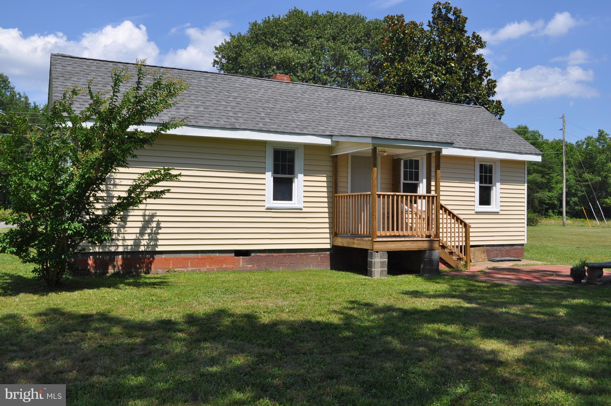 2263 Pomona Road Colonial Beach, VA 22443 - Photo 25 of 28 a front view of a house with yard and green space