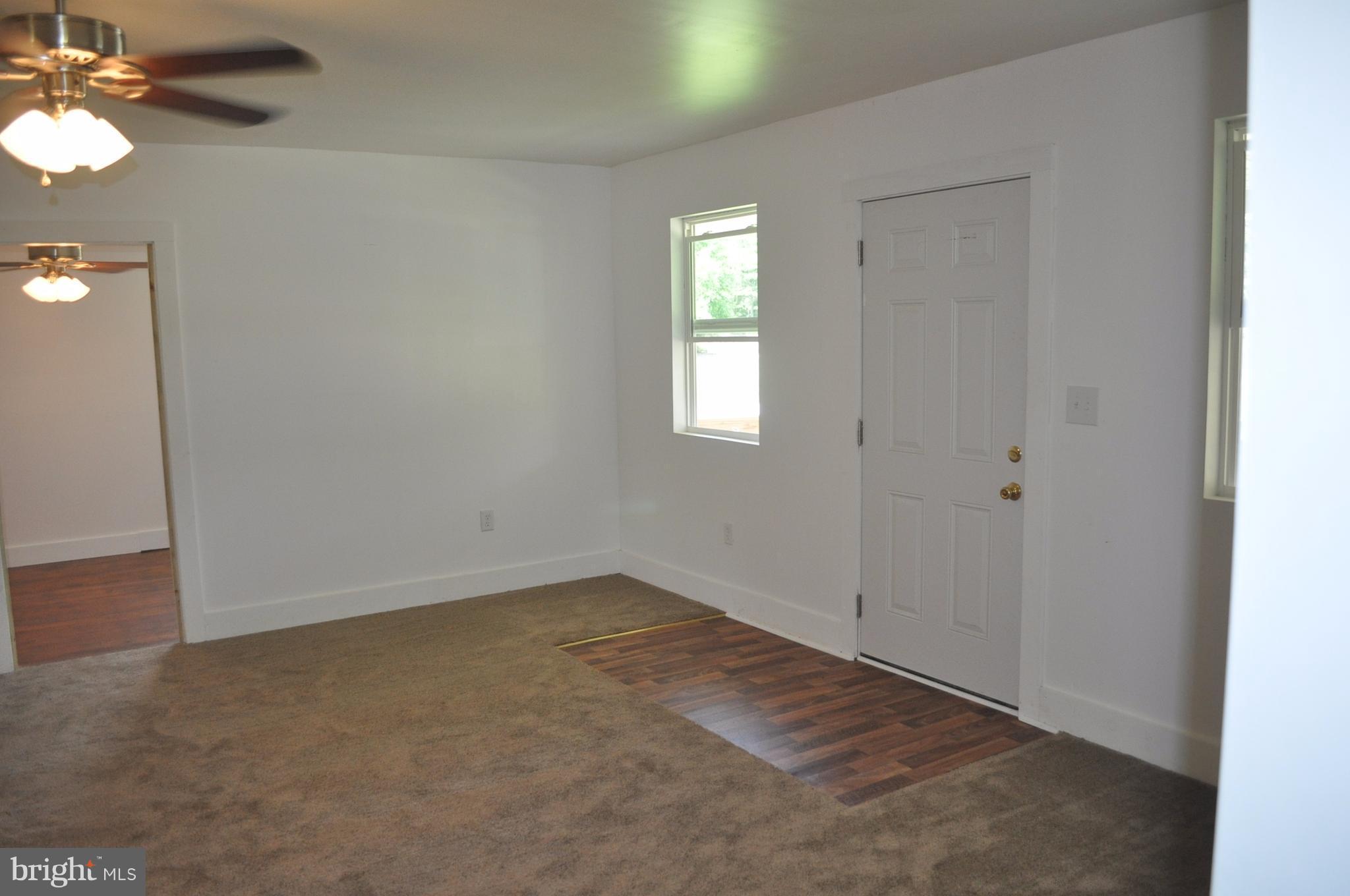 2263 Pomona Road Colonial Beach, VA 22443 - Photo 7 of 28 an empty room with windows and fan