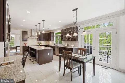 a kitchen with a table chairs refrigerator and microwave
