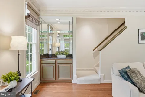 a kitchen with white cabinets and chandelier
