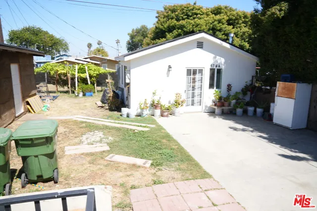 a patio with table and chairs under an umbrella
