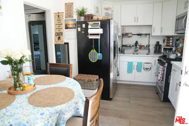 a dining room with furniture and a kitchen view