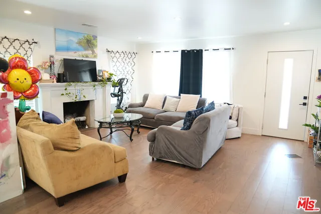 a living room with furniture a fireplace and a flat screen tv