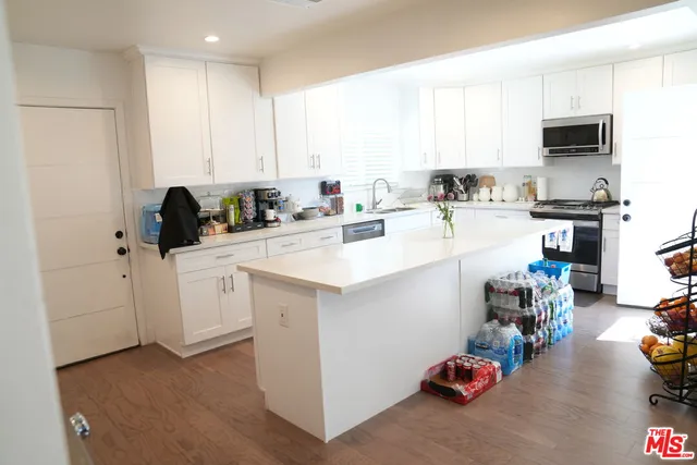 a kitchen with a sink a stove and cabinets