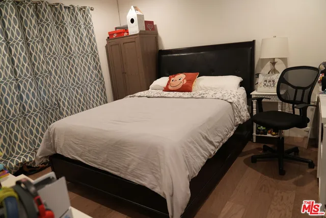 a bedroom with a bed and dresser