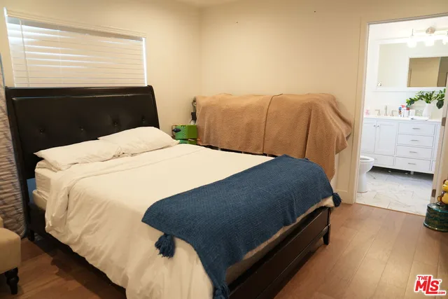 a bed sitting in a bedroom next to a window