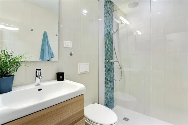 a bathroom with a sink toilet and shower
