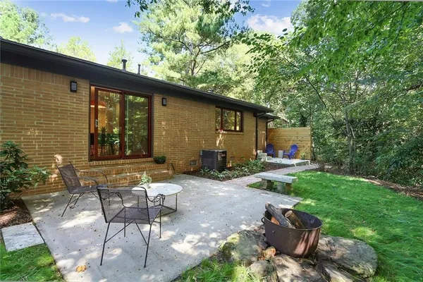 a backyard of a house with table and chairs