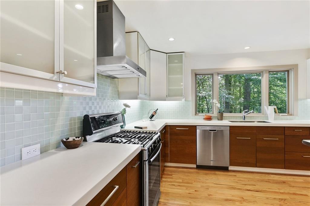 1995 Commodore Lane Atlanta, GA 30341 - Photo 22 of 32 a kitchen with stainless steel appliances a sink a stove and a wooden cabinets