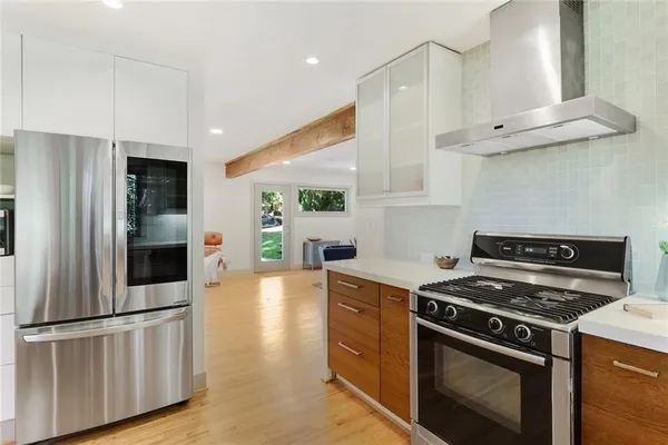 a kitchen with stainless steel appliances granite countertop a stove and a refrigerator