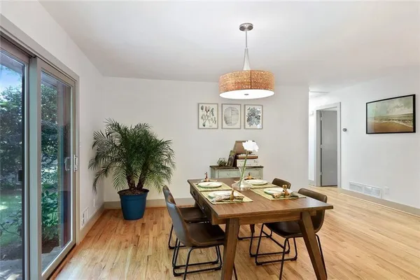 a view of a dining room with furniture window and wooden floor