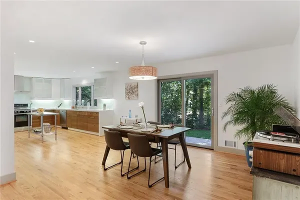 a view of a dining room with furniture window and wooden floor