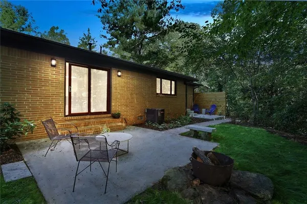 a backyard of a house with outdoor seating