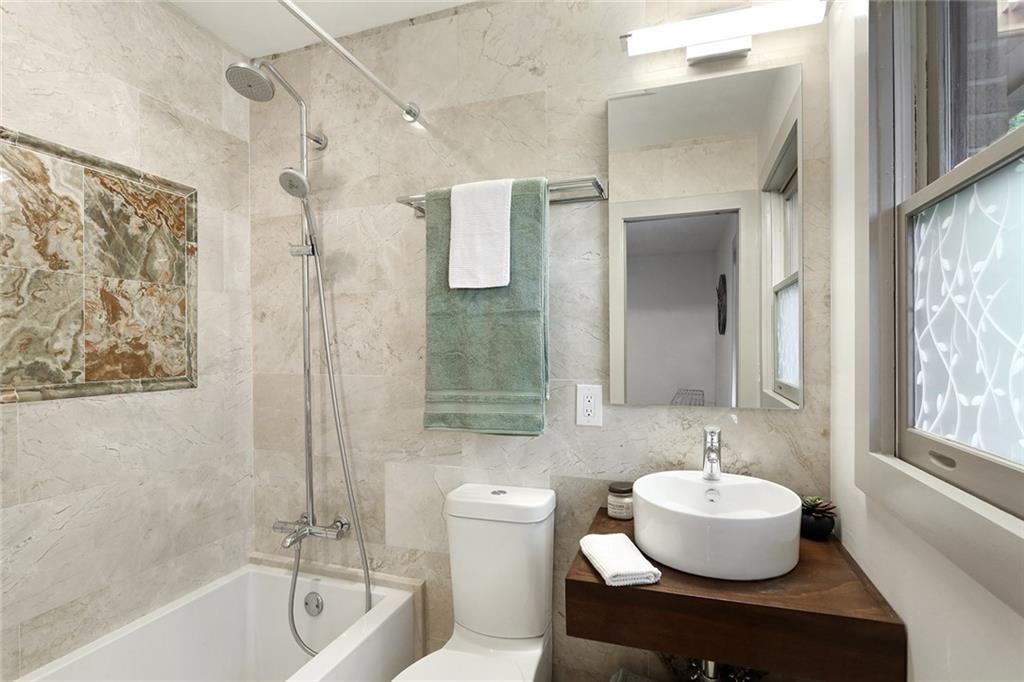 1995 Commodore Lane Atlanta, GA 30341 - Photo 10 of 31 a bathroom with a tub sink and mirror