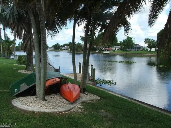 a view of a lake with a garden and a fountain