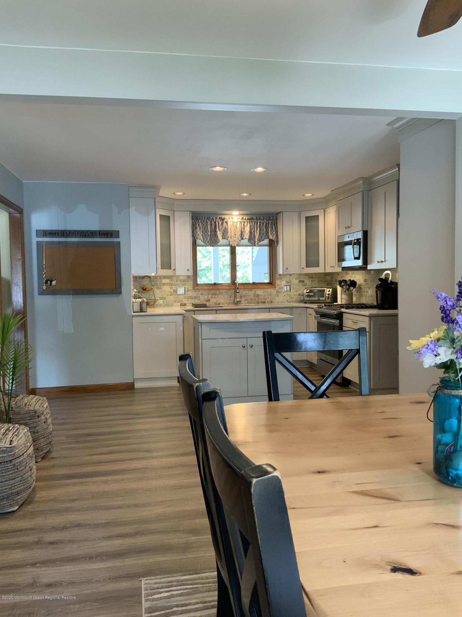 202 Pleasant Drive Brick, NJ 08723 - Photo 11 of 46 a kitchen with stainless steel appliances kitchen island granite countertop a sink and cabinets