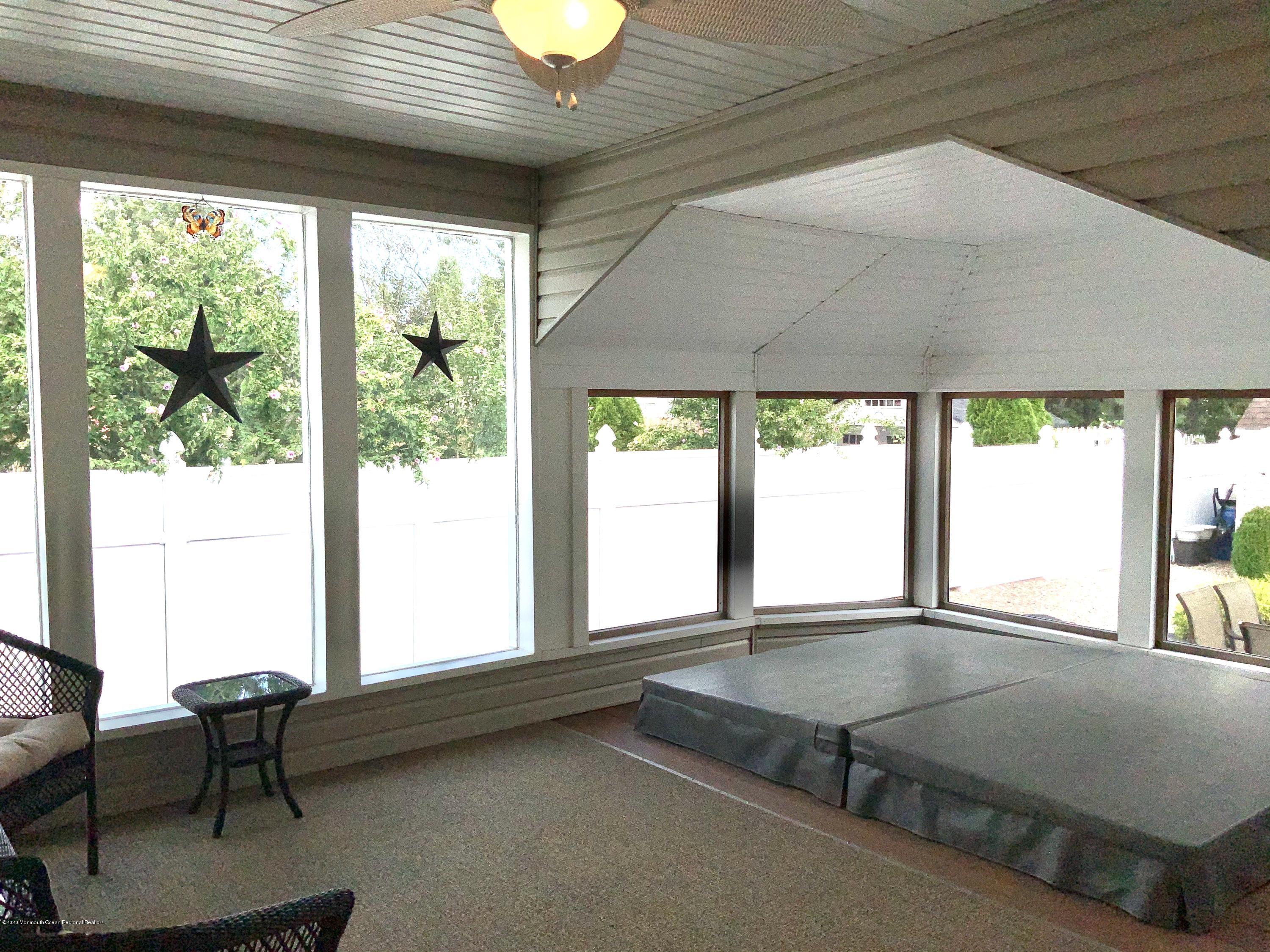202 Pleasant Drive Brick, NJ 08723 - Photo 17 of 46 a living room with a table chair and a large window