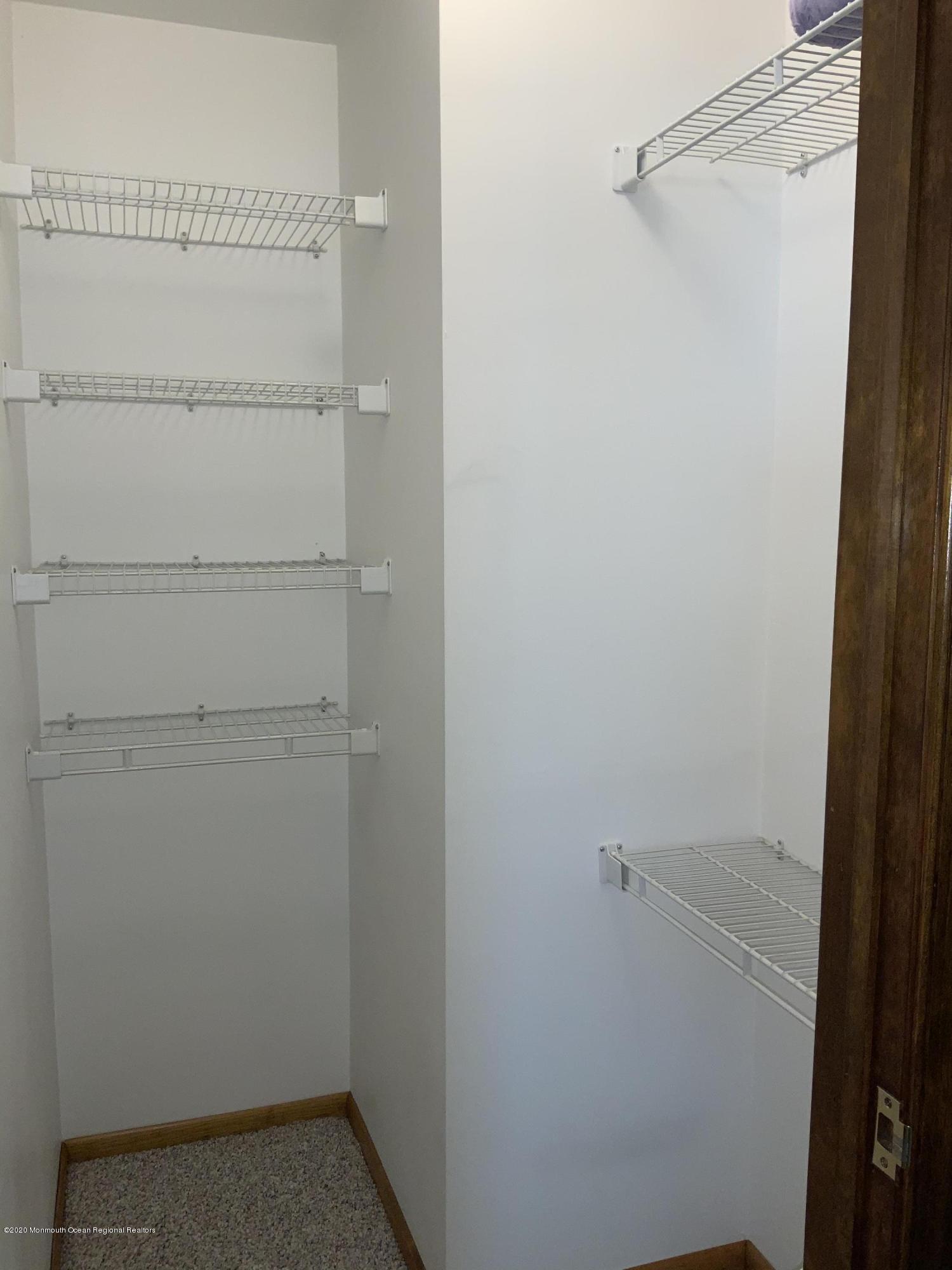 202 Pleasant Drive Brick, NJ 08723 - Photo 27 of 46 a view of a room with racks on the wall