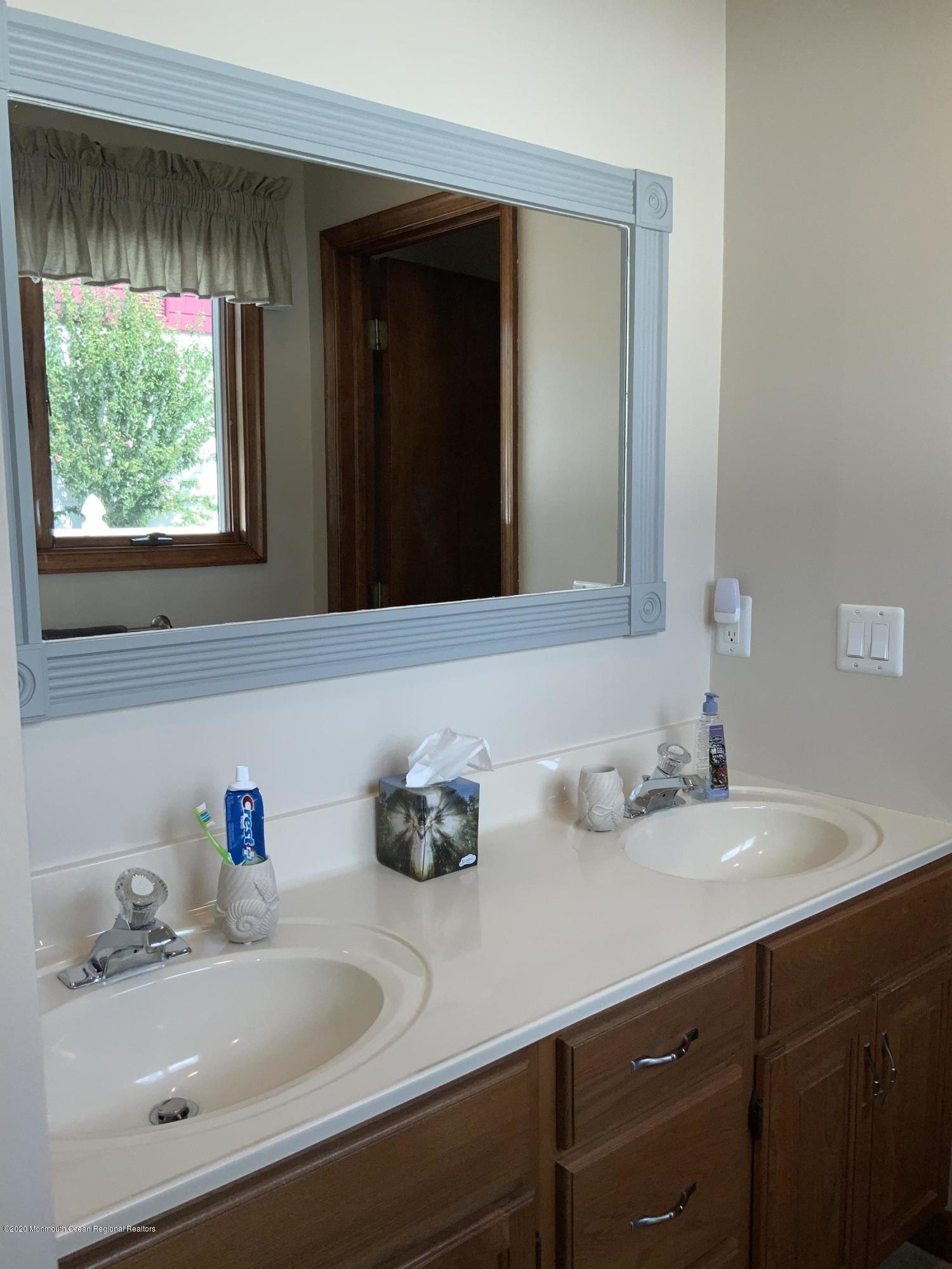 202 Pleasant Drive Brick, NJ 08723 - Photo 29 of 46 a bathroom with a sink and a mirror