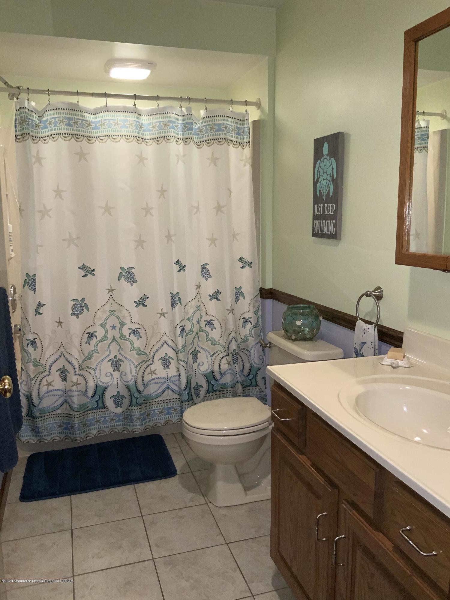 202 Pleasant Drive Brick, NJ 08723 - Photo 31 of 46 a bathroom with a granite countertop sink and a mirror