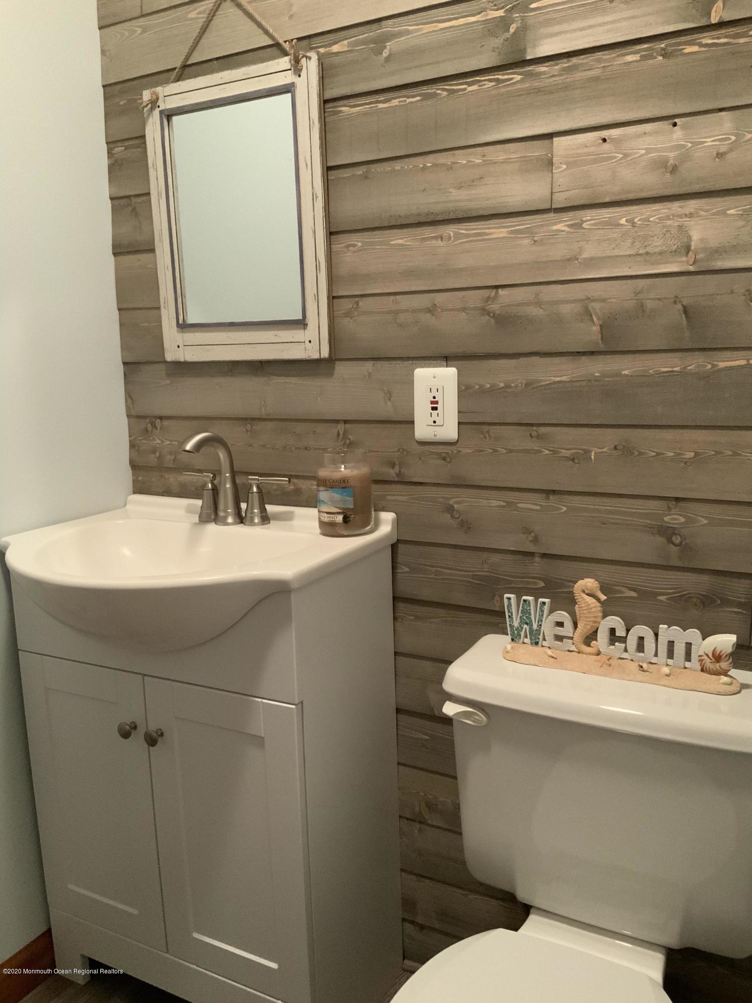 202 Pleasant Drive Brick, NJ 08723 - Photo 33 of 46 a bathroom with a sink a toilet and mirror