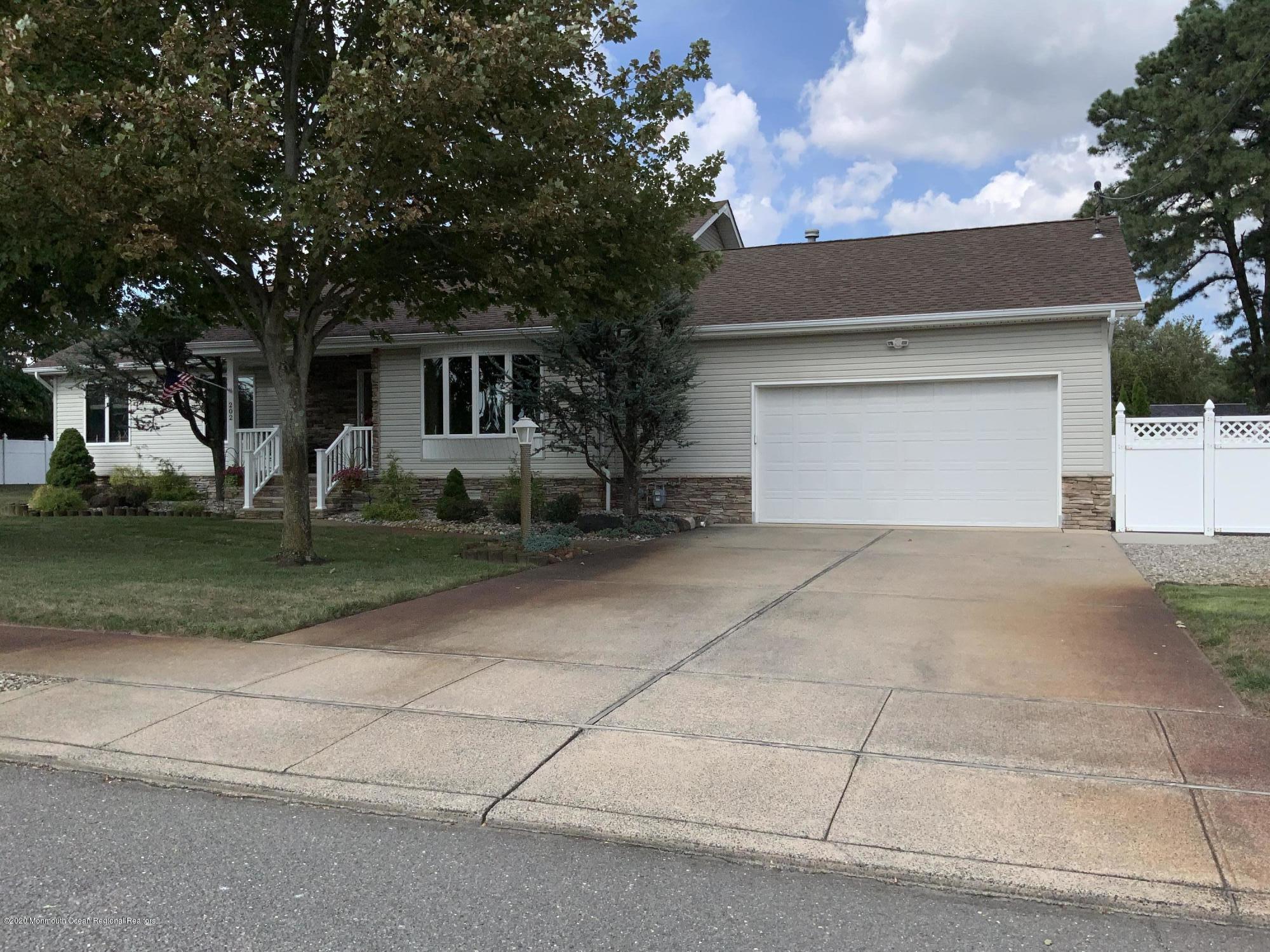 202 Pleasant Drive Brick, NJ 08723 - Photo 41 of 46 a front view of a house with a yard and garage