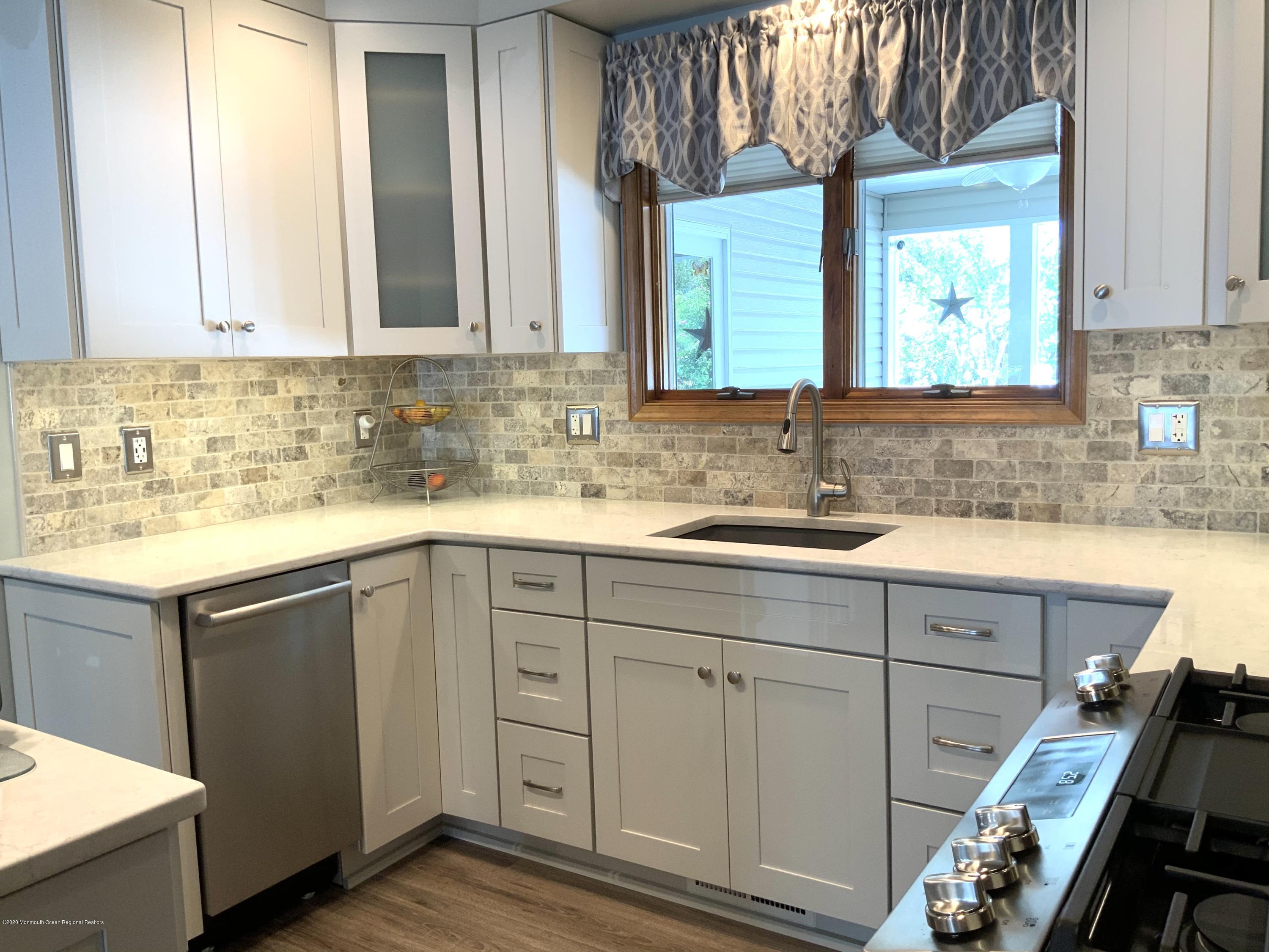 202 Pleasant Drive Brick, NJ 08723 - Photo 5 of 46 a bathroom with a sink and a mirror