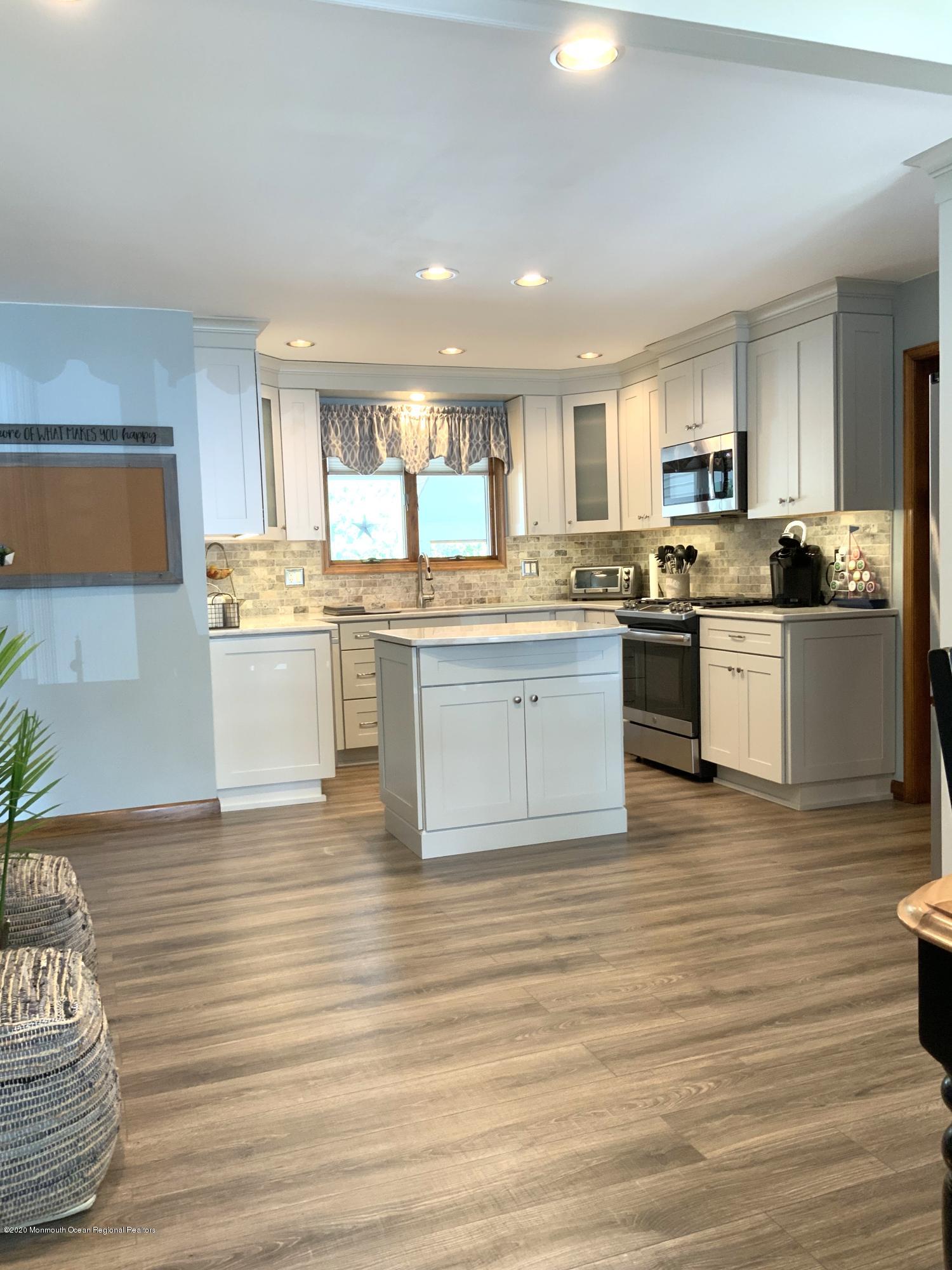 202 Pleasant Drive Brick, NJ 08723 - Photo 9 of 46 a room with stainless steel appliances granite countertop a stove and cabinets