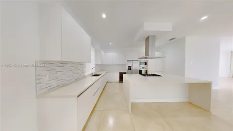 a view of a kitchen with a sink and a chandelier