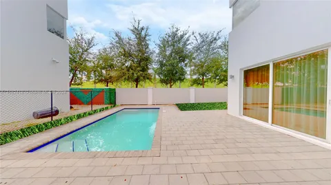 a view of kitchen with stainless steel appliances a refrigerator and cabinets