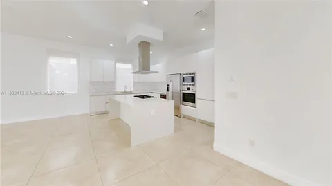 a view of a big room with windows and a chandelier