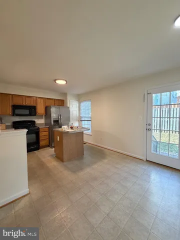 a kitchen with a stove a sink and a microwave