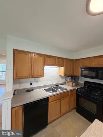a kitchen with stainless steel appliances a refrigerator and a window