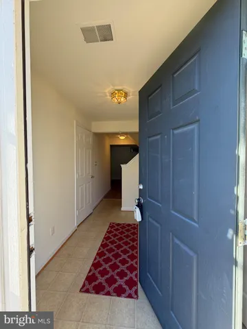 a view of hallway with a chair and front door