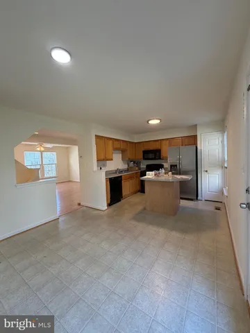 a view of a bedroom with wooden floor and front door