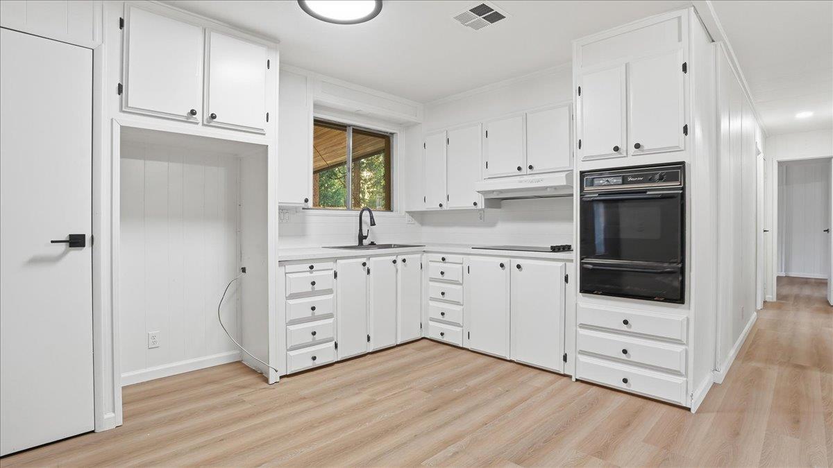 5840 Pony Express Trail, Unit 46 Pollock Pines, CA 95726 - Photo 11 of 22 a kitchen with white cabinets and appliances