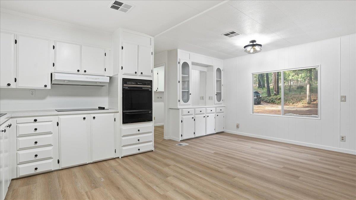 5840 Pony Express Trail, Unit 46 Pollock Pines, CA 95726 - Photo 12 of 22 a kitchen with white cabinets and window
