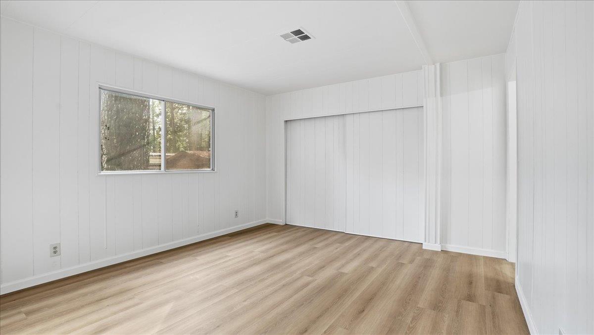 5840 Pony Express Trail, Unit 46 Pollock Pines, CA 95726 - Photo 14 of 22 an empty room with wooden floor and windows