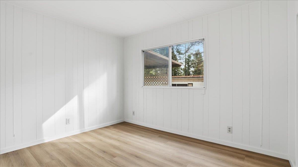5840 Pony Express Trail, Unit 46 Pollock Pines, CA 95726 - Photo 19 of 22 a view of an empty room with wooden floor and a window