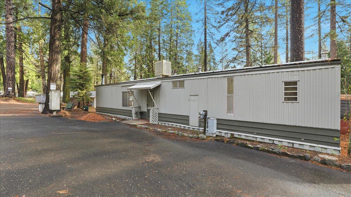 5840 Pony Express Trail, Unit 46 Pollock Pines, CA 95726 - Photo 2 of 22 a view of a house with a large parking space and wooden fence