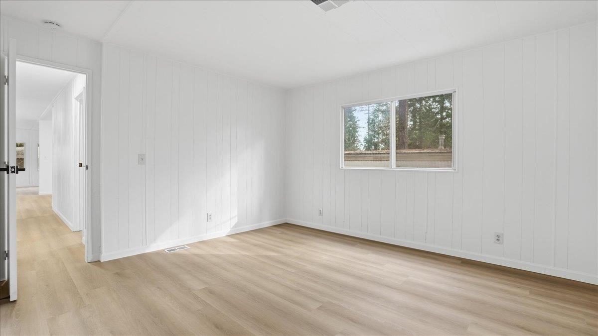 5840 Pony Express Trail, Unit 46 Pollock Pines, CA 95726 - Photo 21 of 22 an empty room with wooden floor and windows