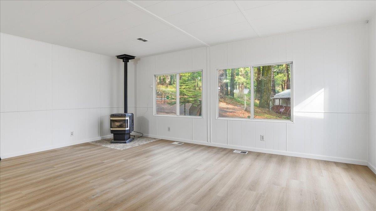 5840 Pony Express Trail, Unit 46 Pollock Pines, CA 95726 - Photo 5 of 22 a view of an empty room with a window and wooden floor