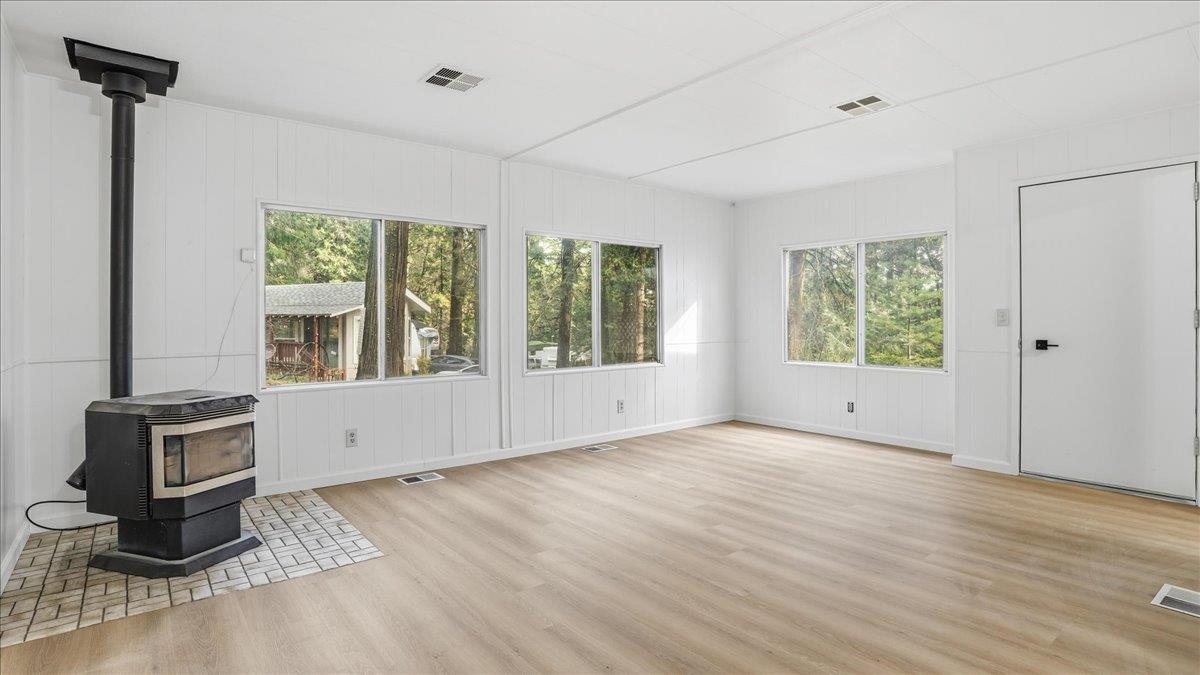 5840 Pony Express Trail, Unit 46 Pollock Pines, CA 95726 - Photo 6 of 22 a view of an empty room with wooden floor and a window