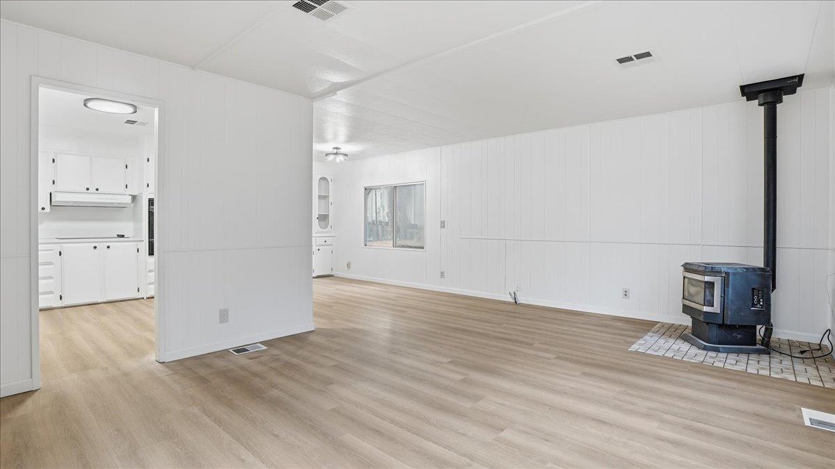 5840 Pony Express Trail, Unit 46 Pollock Pines, CA 95726 - Photo 7 of 22 a view of empty room with wooden floor and fireplace