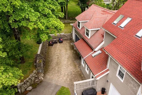 an aerial view of a house with a yard