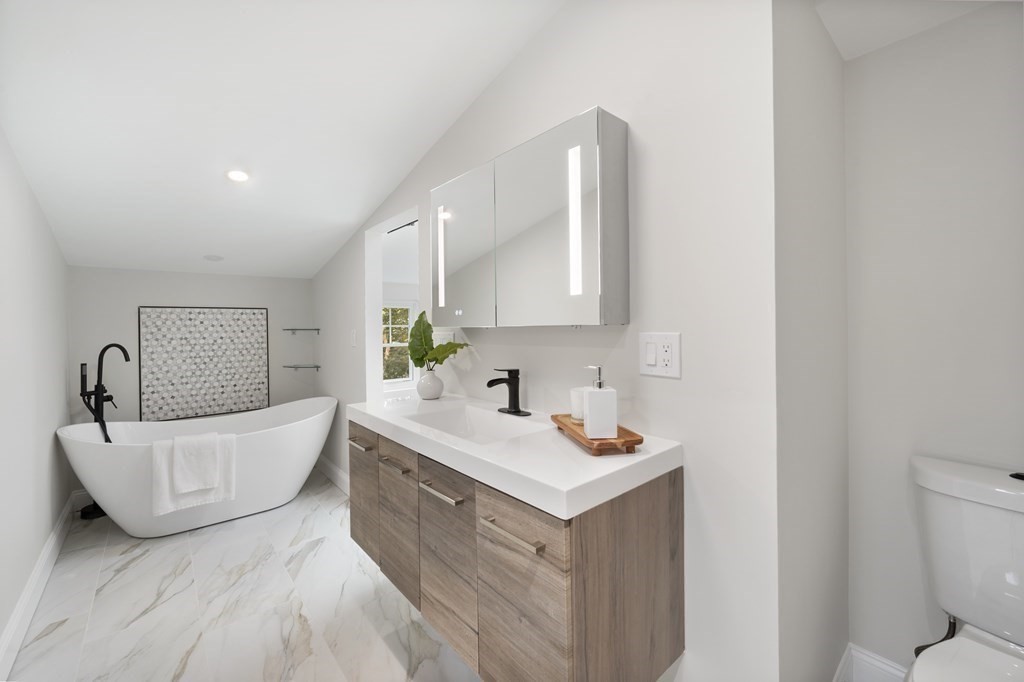 8 Lovell Road Watertown, MA 02472 - Photo 41 of 42 a bathroom with a sink a toilet and a mirror