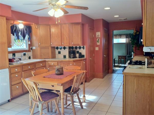 231 Lepes Road Somerset, MA 02726 - Photo 5 of 19 a dining room with a chandelier and wooden floor