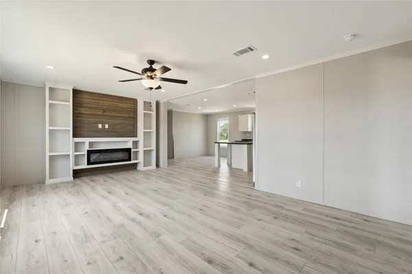 a view of a livingroom with a furniture wooden floor and a ceiling fan